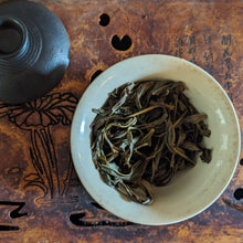 Da Wu Ye Dancong oolong tea that has been brewed, in a gaiwan with a white ceramic interior